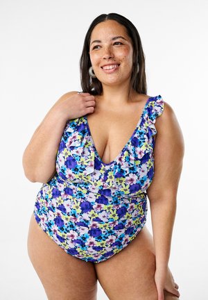 Costume da bagno intero floreale con spalline arricciate, caratterizzato da un mix di colori viola, blu e verde su uno sfondo bianco. Tessuto morbido con vestibilità elastica.