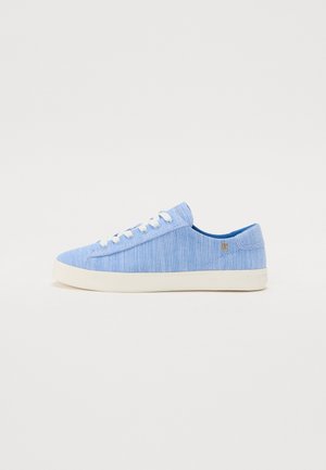 Light blue canvas sneaker with a textured surface, white laces, and a cream-colored rubber sole. Features a small logo accent on the side.
