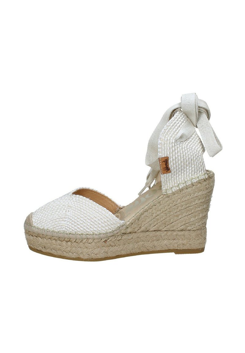 Sandalo con tacco wedge in espadrilles intrecciate bianche, con una parte superiore testurizzata, design con punta aperta e una cinghia alla caviglia in tessuto annodata. Base in juta.