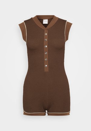 Brown textured romper with a collar, cap sleeves, five silver buttons down the front, and light brown piping detailing along the edges.