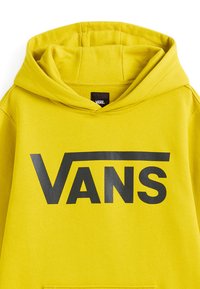 Felpa gialla con il logo Vans nero stampato sulla parte anteriore. Presenta un cappuccio con coulisse e polsini a costine. Realizzata in tessuto morbido.