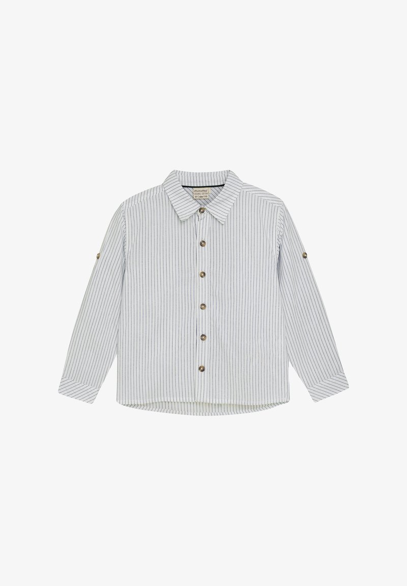 Dryžuota šviesiai mėlyna ir balta marškinėlių mygtukų versija, pagaminta iš minkštos medžiagos. Yra apykaklė, ilgomis rankovėmis ir penkiomis rudos spalvos mygtukais priekyje.