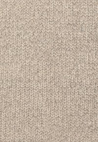Tessuto lavorato a maglia beige chiaro con una trama tessuta a strati e morbida. La superficie presenta un pattern sottile e può avere fibre naturali morbide.