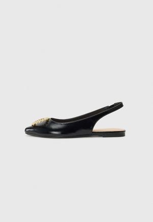 Black leather slingback flat with a pointed toe, featuring a decorative gold embellishment on the front and a minimalistic design.