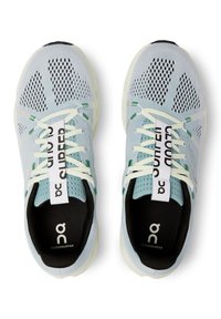 Light blue breathable running shoes with a mesh upper, contrasting black insole, and green accents. Secure lace-up design with logo details.