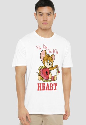 Man wearing white t-shirt with cartoon mouse holding heart-shaped lock and key, text above and below reads "The Key To My Heart."