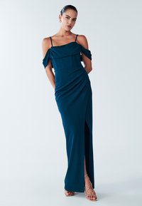 Sinivihreä iltapuku, jossa olkapäät paljastavat hihat, vartalonmyötäinen yläosa ja ryppyinen yksityiskohta, sivuhalkio ja sileä pinta.