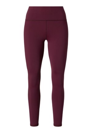 Hochgeschnittene Leggings in tiefem Burgunderrot, aus dehnbarem Material gefertigt. Sie weisen eine glatte Textur und eine enganliegende Passform auf, die an den Knöcheln zuläuft.
