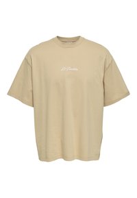 Beige oversized T-Shirt aus Baumwolle, mit kurzen Ärmeln und rundem Ausschnitt. "Le Passion" ist in Weiß auf der Brust gestickt.