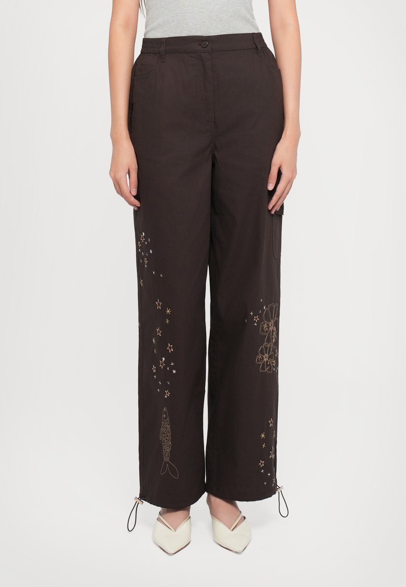 Black wide-leg pants featuring embroidered fish and star patterns, with drawstring hems and a button closure at the waistband.