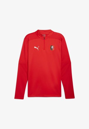 Roter langärmliger Sportpullover mit Reißverschlusskragen, Puma-Logo auf der rechten Brust und Stade Rennais Fußballclub-Abzeichen auf der linken Brust.