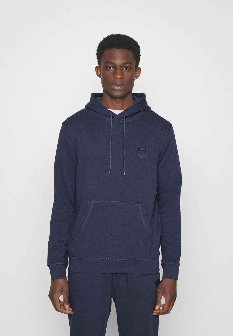 Navy blue hoodie made of soft fabric, featuring a front pocket, adjustable drawstring hood, and subtle logo patch. Simple and comfortable design.