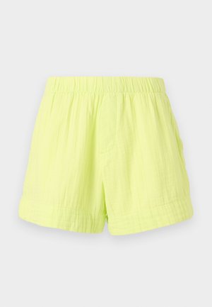 Pantalones cortos verde lima hechos de una tela ligera y texturizada, con una cintura elástica y un bolsillo lateral. Sin cierres visibles.