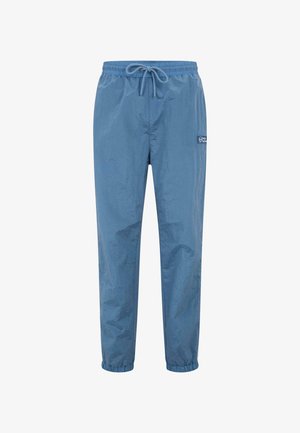 Heledad sinine veekindel püksid, mis on valmistatud kortsus nailonist, omavad elastset vööd koos nööriga ja elastseid krae pahkluude juures. Küljel on brändi logo.