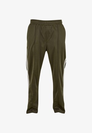 Olivgröna träningsbyxor med dragsko i midjan, slät textur, två vita sidosträck och subtil sömdetaljering framtill.