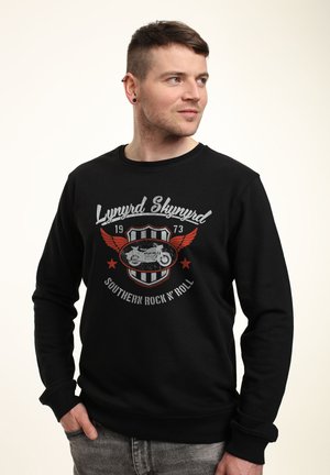 Černá mikina vyrobená z bavlny s dlouhými rukávy, se stylovým potiskem motocyklisty a textem "Lynyrd Skynyrd Southern Rock 'N' Roll."