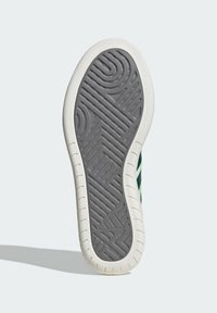 Shoe sole features a textured gray rubber surface with a white edge. Notable patterns include spirals and angular shapes for traction.