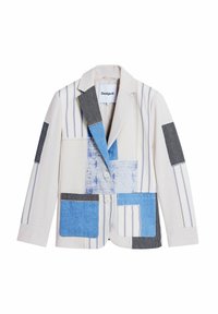 Patchwork blazer featuring a beige base with blue, black, and white striped patterns. Two buttons and diverse fabric textures in a modern cut.