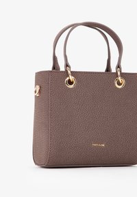 Borsa a tracolla in finta pelle marrone con doppie maniglie superiori, hardware dorato e logo impresso sul davanti. Forma rettangolare.