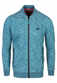 Veste zippée bleu texturée avec col côtelé, fermeture éclair noire, deux poches zippées, et un logo discret sur la poitrine.