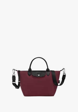 Maroon nylon bag with black leather accents, dual handles, removable shoulder strap, and logo button detail on the front.