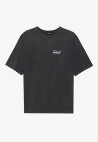Black cotton t-shirt with a loose fit, featuring “PHASES OF THE MOON” text in white on the left chest. Short sleeves, crew neck design.