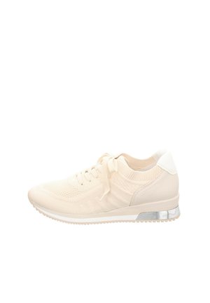 Beige knit sneakers with a textured upper, lace closure, and a white heel accent. Features a reflective silver heel detail and rubber sole.