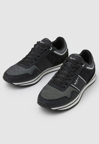 Black and gray sneakers with a textured upper, lace closure, white stripes, and logo detail on the side; cushioned sole for comfort.