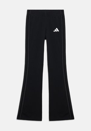 Black flared athletic pants made of soft fabric with an elastic waistband, featuring white side stripes and a white logo on the hip.
