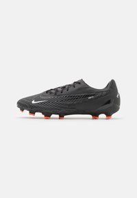Black soccer cleats with a textured upper, featuring a sleek design, orange studs, and silver Nike branding. Streamlined profile with lace closure.