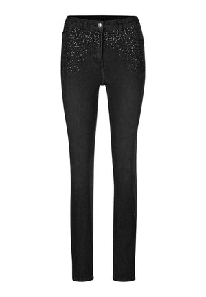 Zwarte skinny jeans met diepe voorzakken, knoopsluiting en verspreide kleine zilveren studs die het bovenste voorgebied versieren.
