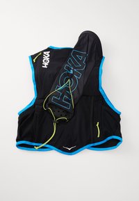 Black running vest with blue accents, featuring breathable fabric, adjustable straps, and a storage pocket. Large "HOKA" logo displayed.