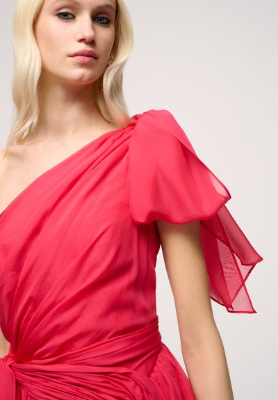 Asymmetrical one-shoulder dress in bright pink, made of lightweight fabric. Features a gathered puff sleeve and a tied waist detail.