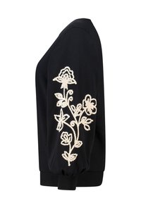 Zwarte sweatshirt met lange mouwen, met witte bloemenborduursels aan de linkerkant en geribde manchetten voor een gegoten pasvorm.