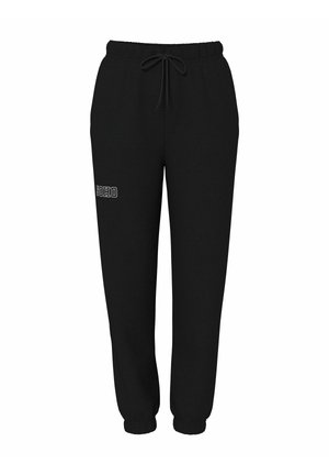 Svarta sweatpants av mjukt tyg, med elastisk midja och dragsko, elastiska muddar samt en vit "SOHO"-tryck på framsidan.
