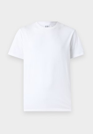 Balta medvilnės marškinėliai su apvaliu iškirpimu ir trumpomis rankovėmis. Paprastas dizainas be raštų ar grafikų, su "GAP" ženklu ant apykaklės.