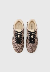 Leopard print sneakers with a soft beige lining and black laces. Features a brown rubber sole and cream-colored side accents.