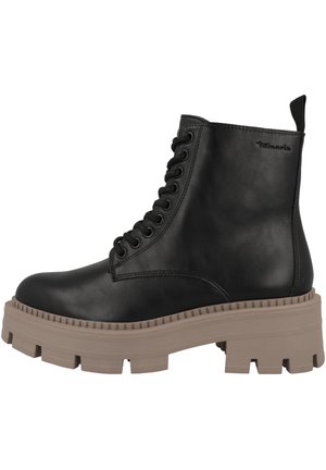 Black leather ankle boot with lace-up design, featuring a pronounced chunky light brown sole and a pull tab at the heel.