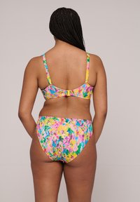 Conjunto de bikini con un diseño floral multicolor en rosa, amarillo y verde. Tirantes ajustables y cierre de gancho en la parte de atrás.