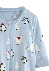 Light blue onesie featuring penguin and polar bear illustrations, winter-themed with snowflakes and trees, made from soft cotton material.