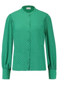 Blouse verte à manches longues avec des pois noirs, col rond et détails froncés aux épaules et aux poignets.