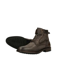 Bruine leren enkelboots met een gestructureerd oppervlak, ronde neus en vetersluiting. Dikke zwarte rubberen zool met een patroon voor grip.