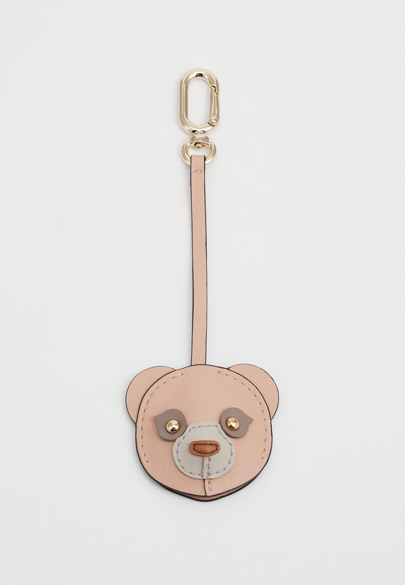 Leather bear keychain in light pink, featuring gold hardware, a gray snout, and brown accents. Flat design with a strap for attachment.