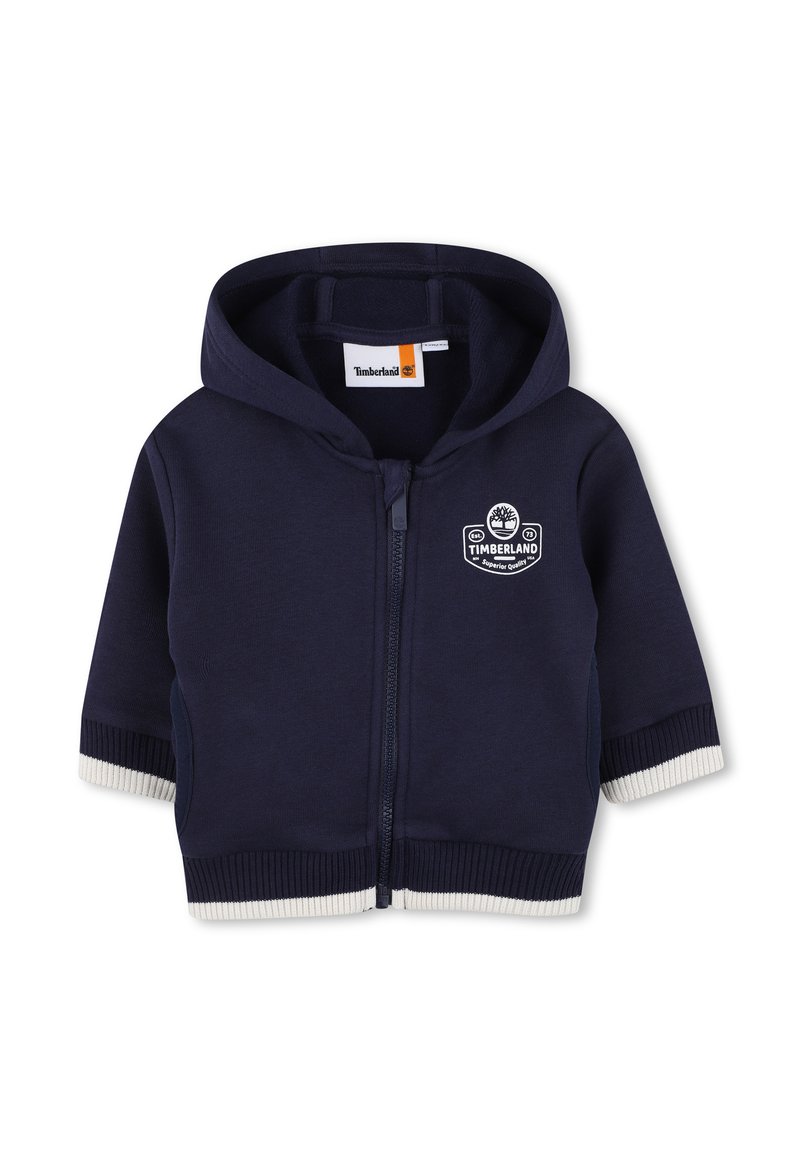Felpa con zip blu navy per bambini, con cappuccio, polsini e fondo a coste bianchi, logo Timberland sul petto e tasche frontali.