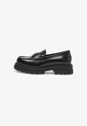 Black leather loafers with a glossy finish, featuring a decorative gold-tone hardware accent and thick, textured rubber sole.
