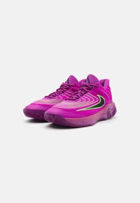 Nike-sko i livlig pink med en glat tekstur, der har neongrønne accenter og et bølget stribet design på overdelen. Gummiydersål.