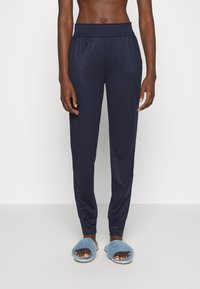Marineblauwe joggingsbroeken met een elastische tailleband en boorden, gemaakt van een lichtgewicht stof. Kenmerkt zich door een relaxte pasvorm en een gladde textuur.