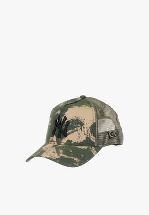 Camouflage baseball cap with a green and beige pattern, mesh back, curved visor, and embroidered black logo on the front.