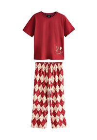 Red cotton t-shirt with a swan graphic and heart detail, paired with cream pants featuring a red diamond swan pattern and an elastic waistband.