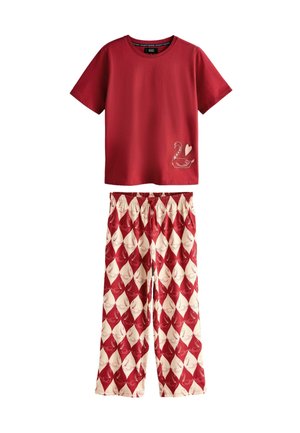 Red cotton t-shirt with a swan graphic and heart detail, paired with cream pants featuring a red diamond swan pattern and an elastic waistband.